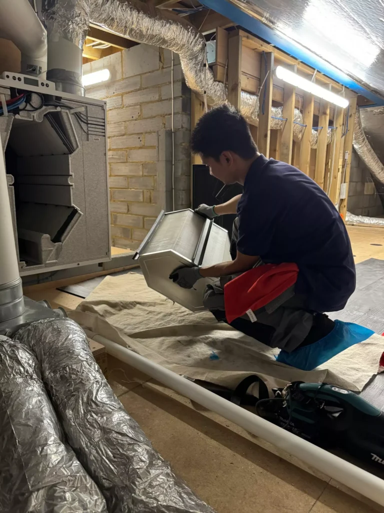 Cool Runnings Technician Fixing and Servicing a Ventilation System